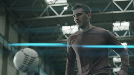 Football-Player-Juggling-Ball-on-Indoor-Field